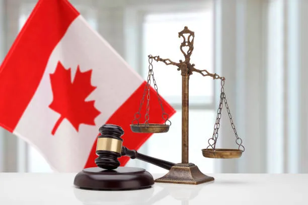 Lady Justice statue alongside the Canadian flag — Maplehurst Legal Group brand visual
